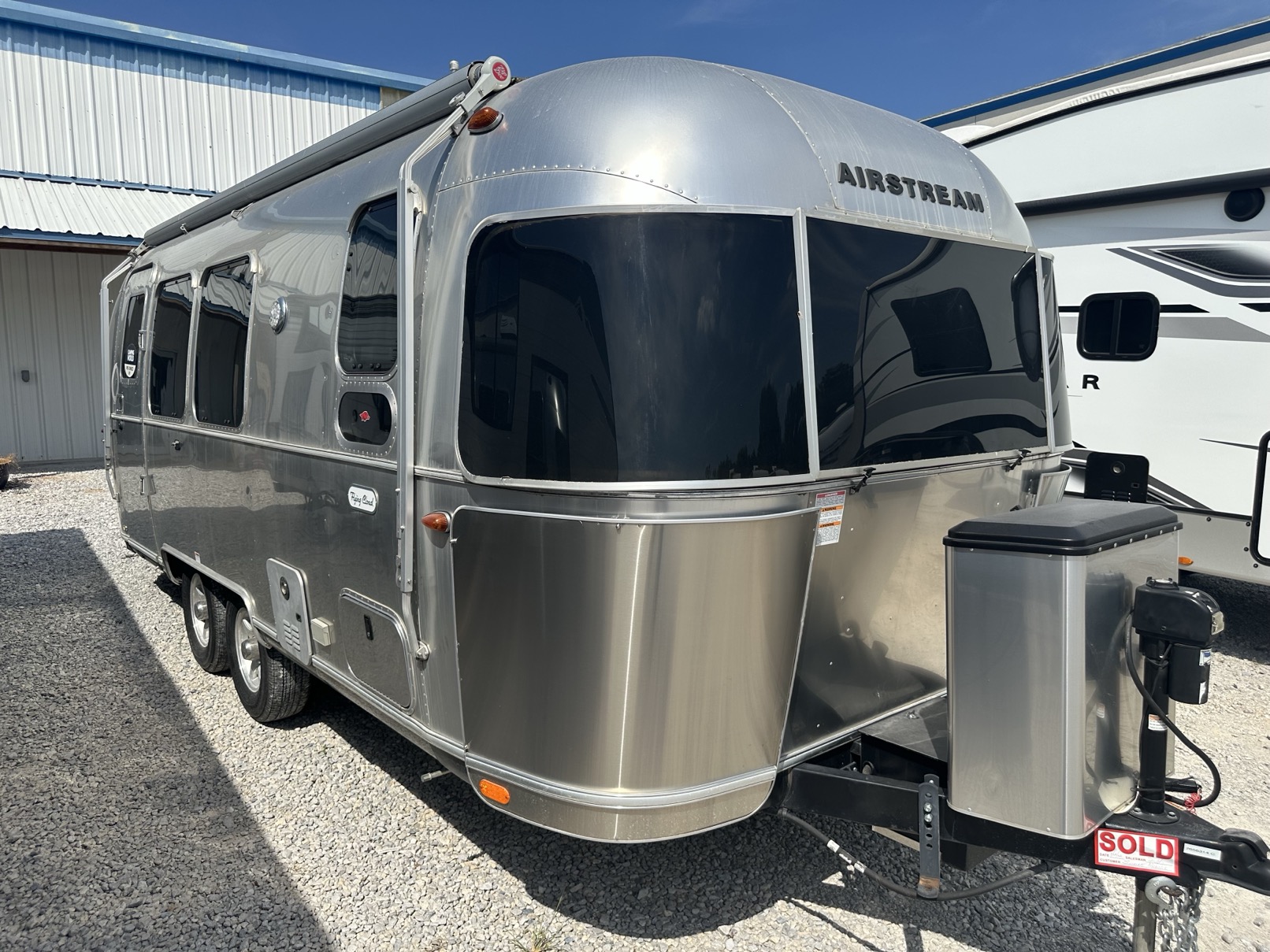 A 2021 Airstream Flying Cloud 23FB travel trailer parked on a dealership lot